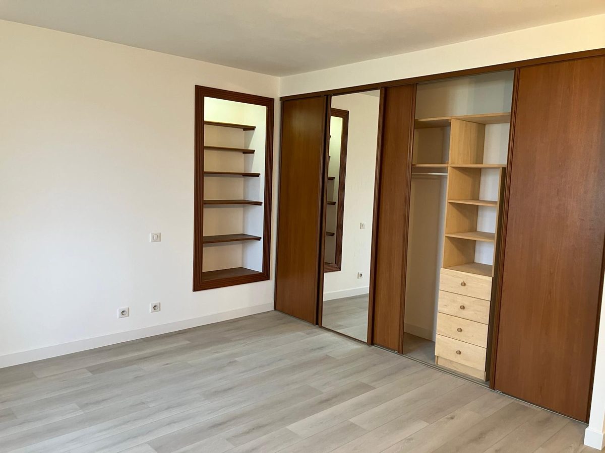 Chambre finie avec placards intégrés remis en peinture et sol stratifié clair posé